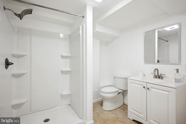 bathroom with vanity, toilet, and a shower