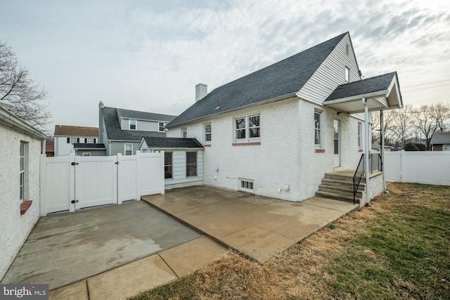 rear view of property featuring a patio