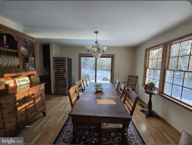 dining space with an inviting chandelier and hardwood / wood-style floors