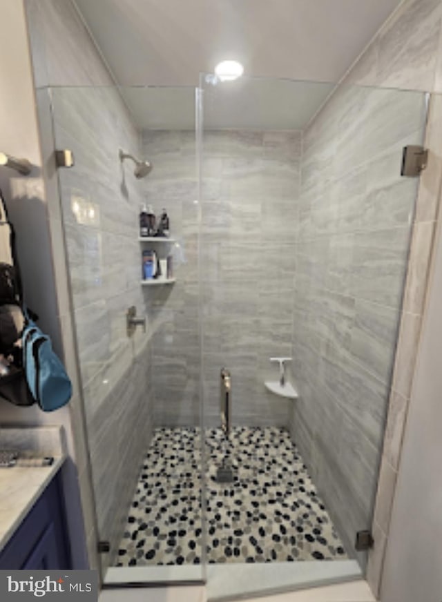 bathroom featuring an enclosed shower and vanity