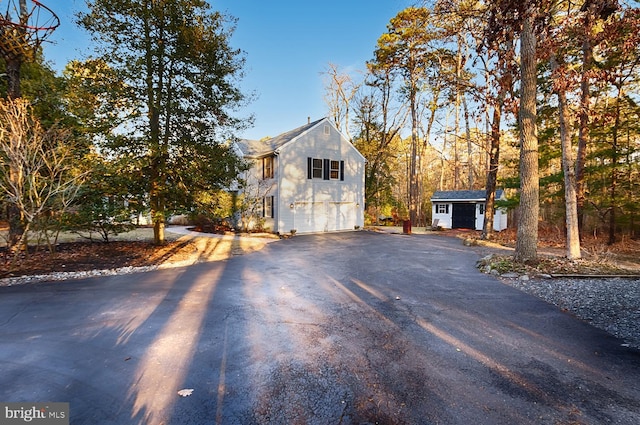 view of home's exterior with an outbuilding and a garage
