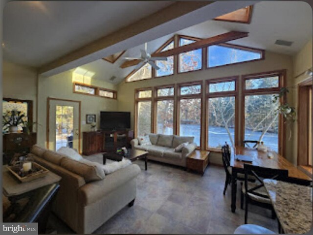 living room with ceiling fan, high vaulted ceiling, and beamed ceiling