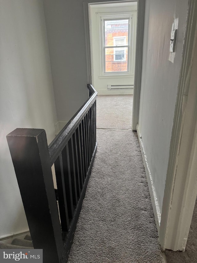 corridor featuring a baseboard radiator and carpet flooring