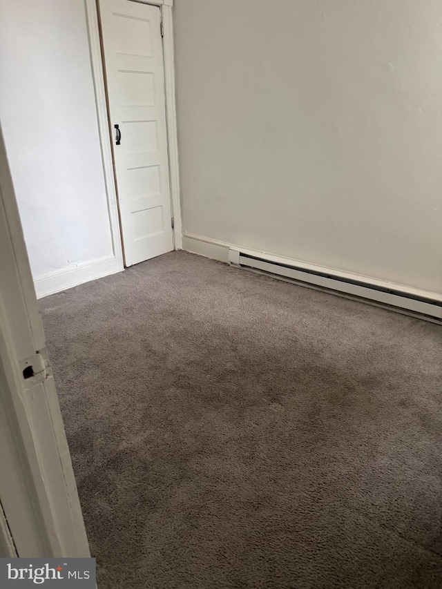 empty room with baseboards, carpet flooring, and baseboard heating