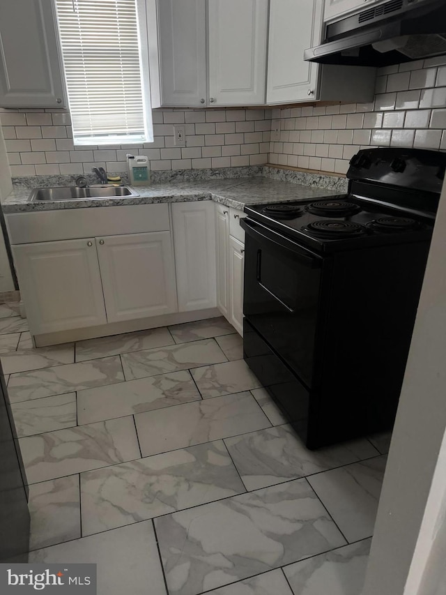 kitchen featuring under cabinet range hood, a sink, white cabinetry, marble finish floor, and black electric range oven