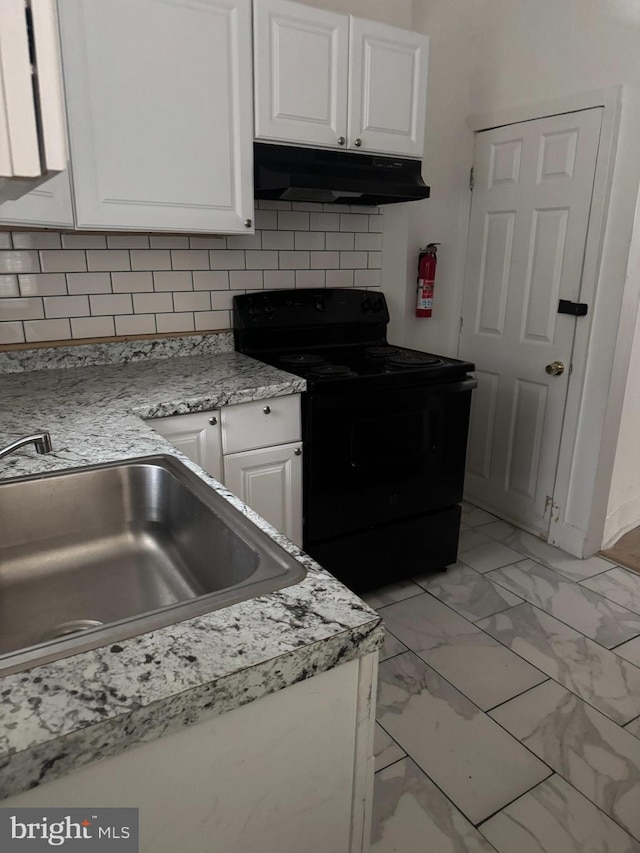 kitchen with under cabinet range hood, marble finish floor, white cabinets, and black electric range oven