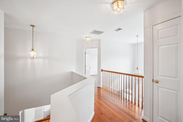 hallway featuring visible vents and light wood-style floors