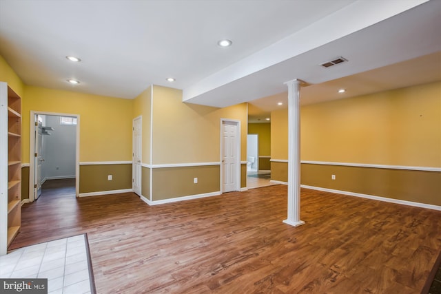 finished below grade area featuring baseboards, wood finished floors, visible vents, and recessed lighting