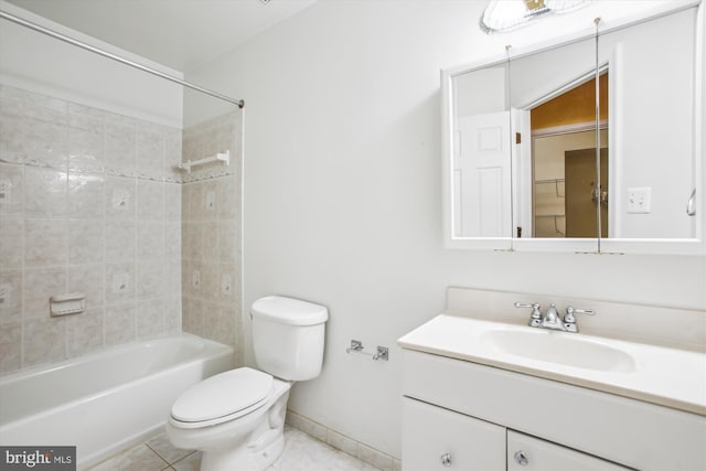 full bath with shower / bath combination, toilet, vanity, baseboards, and tile patterned floors