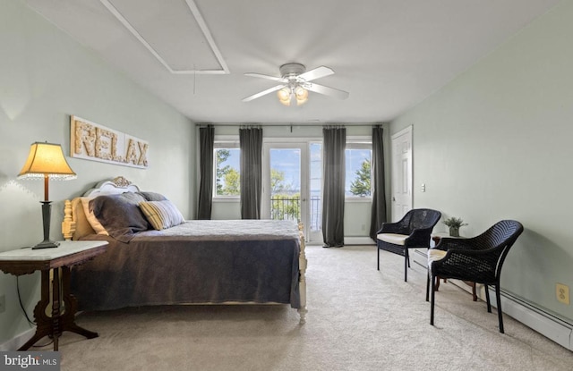 carpeted bedroom with multiple windows, access to exterior, ceiling fan, and a baseboard heating unit