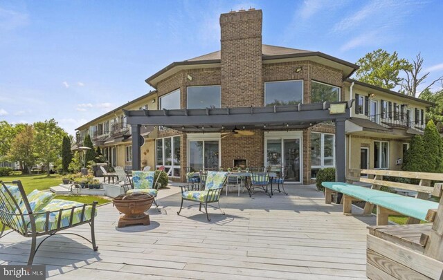 deck featuring an outdoor living space and a pergola