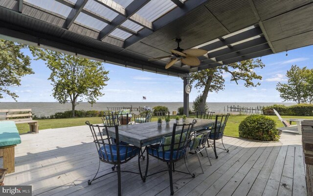 wooden deck featuring a yard, ceiling fan, and a water view