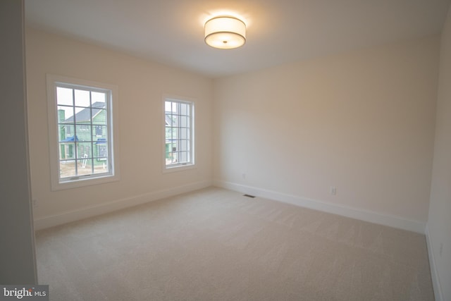 empty room featuring light colored carpet