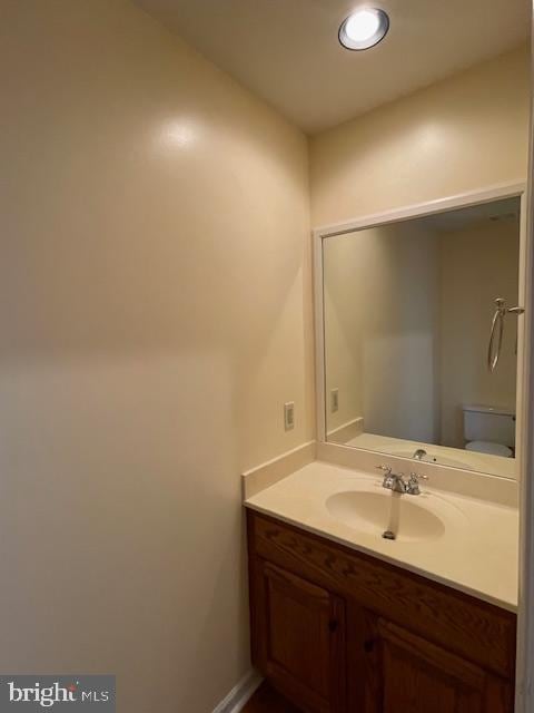 bathroom featuring vanity and toilet