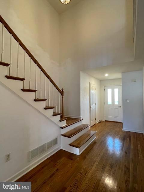 entrance foyer with a high ceiling and dark hardwood / wood-style floors