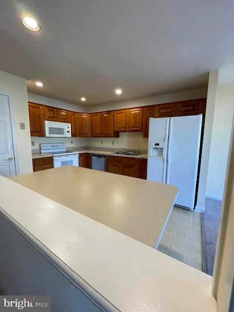 kitchen featuring sink and white appliances