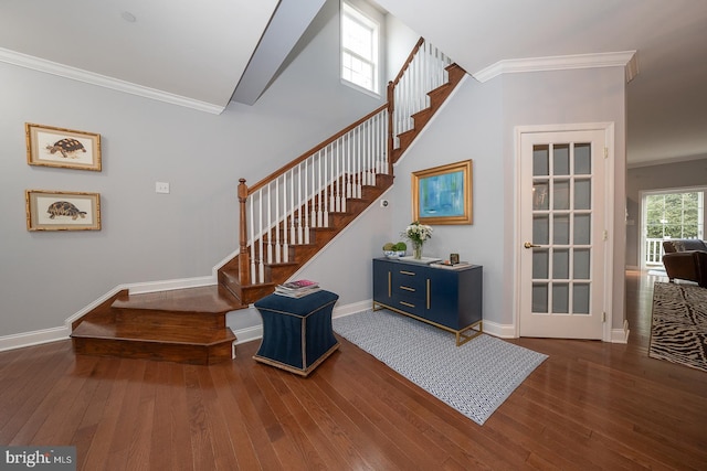 stairway with crown molding and wood-type flooring