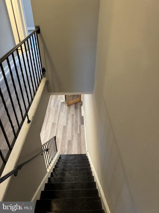 stairway with hardwood / wood-style floors