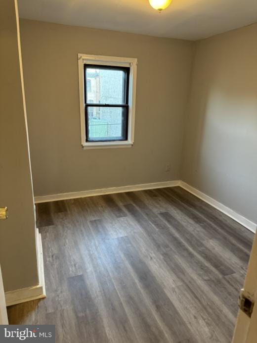 unfurnished room featuring dark hardwood / wood-style floors