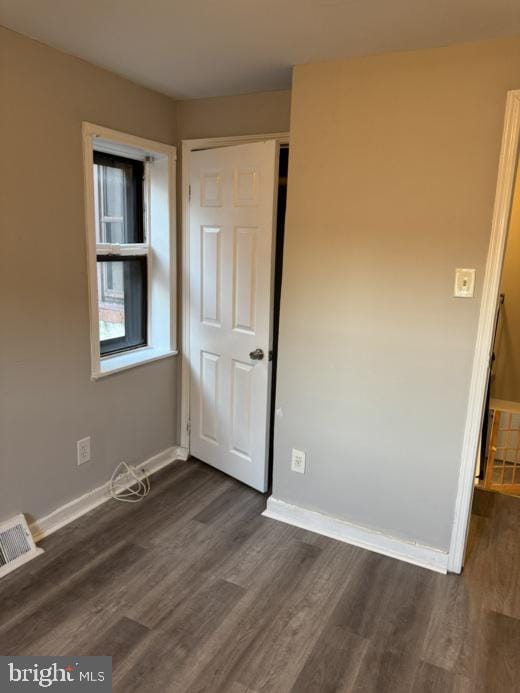 unfurnished bedroom featuring dark wood-type flooring