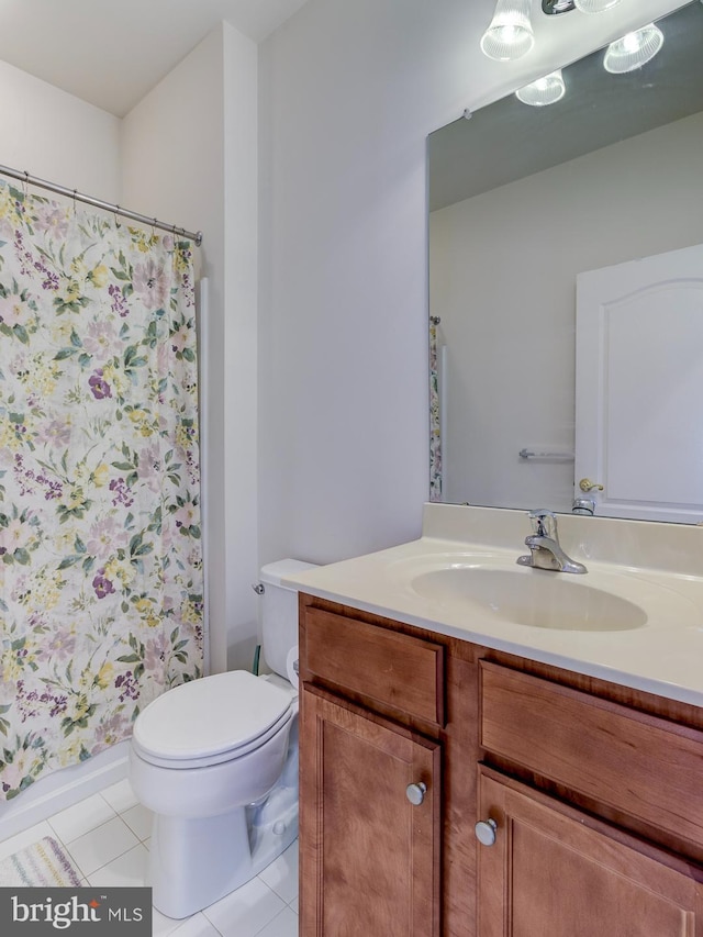 bathroom featuring tile patterned floors, toilet, and vanity