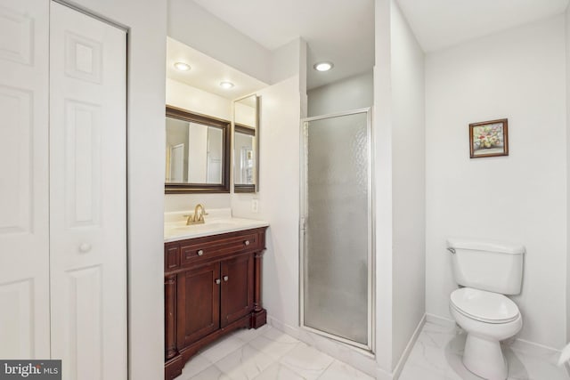 bathroom featuring vanity, toilet, and a shower with shower door