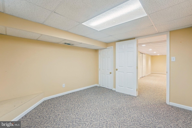 basement with carpet and a drop ceiling