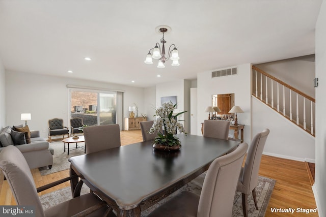 dining room with a chandelier and light wood-type flooring