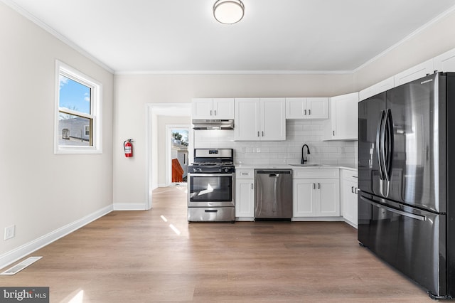 kitchen with sink, light hardwood / wood-style floors, white cabinets, and appliances with stainless steel finishes