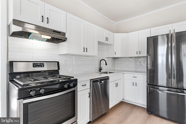 kitchen with sink, crown molding, white cabinetry, stainless steel appliances, and light stone countertops