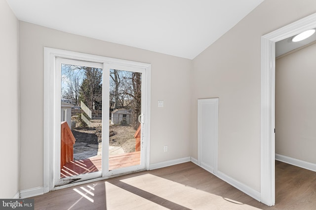 entryway featuring hardwood / wood-style flooring and vaulted ceiling