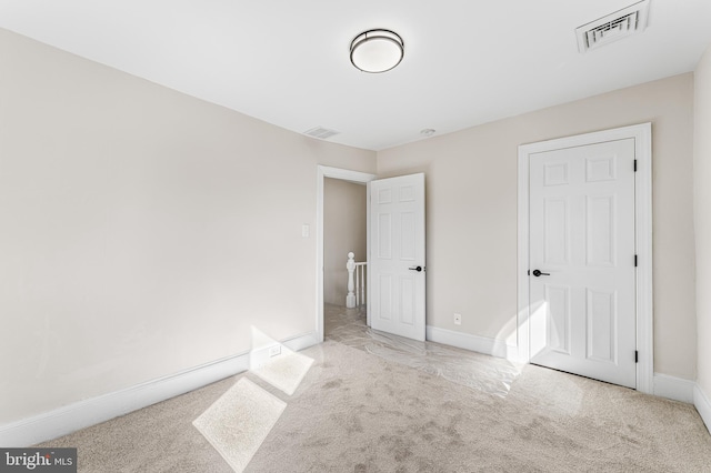 unfurnished bedroom with light colored carpet