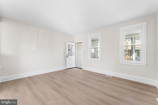 unfurnished room with light hardwood / wood-style flooring