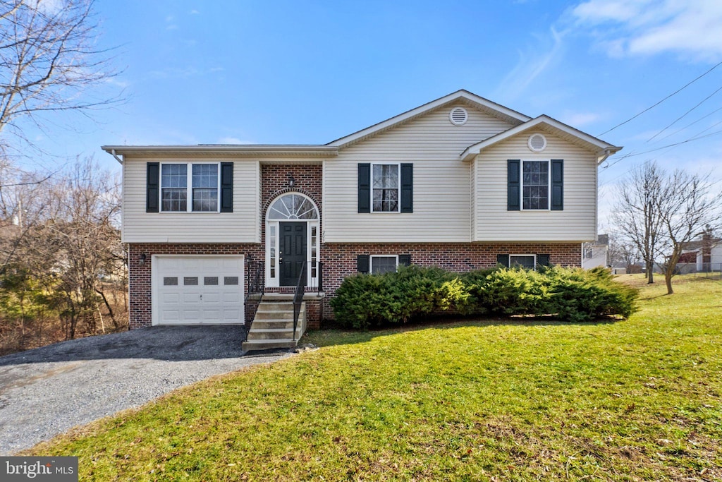 bi-level home with a garage and a front yard