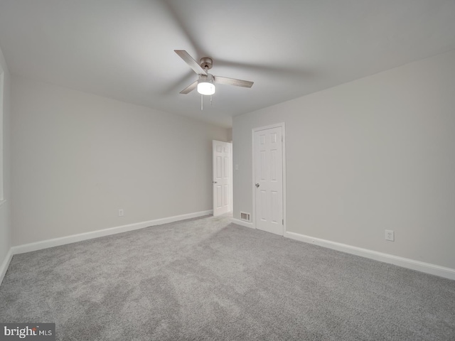 carpeted spare room with ceiling fan