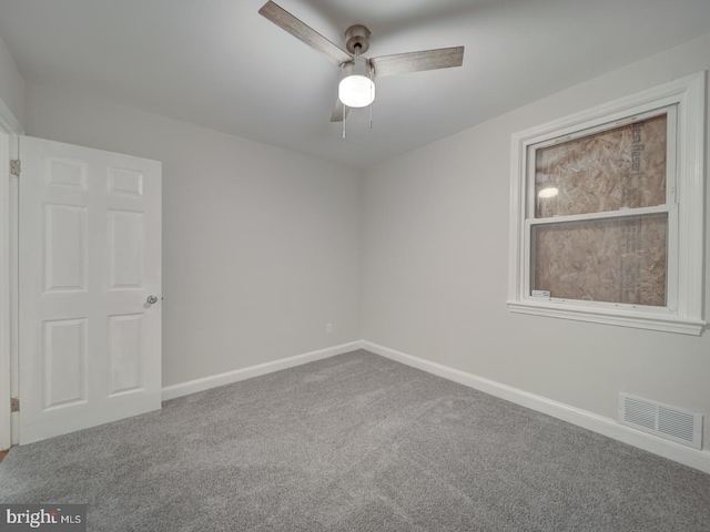 empty room featuring carpet flooring and ceiling fan