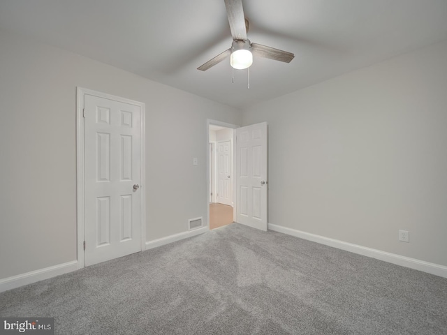 empty room with carpet and ceiling fan