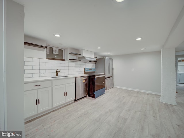 kitchen featuring white cabinetry, sink, backsplash, and appliances with stainless steel finishes