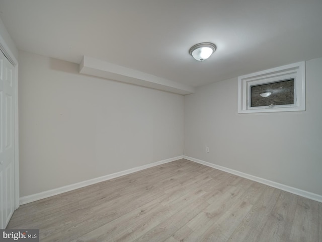 basement with light hardwood / wood-style floors