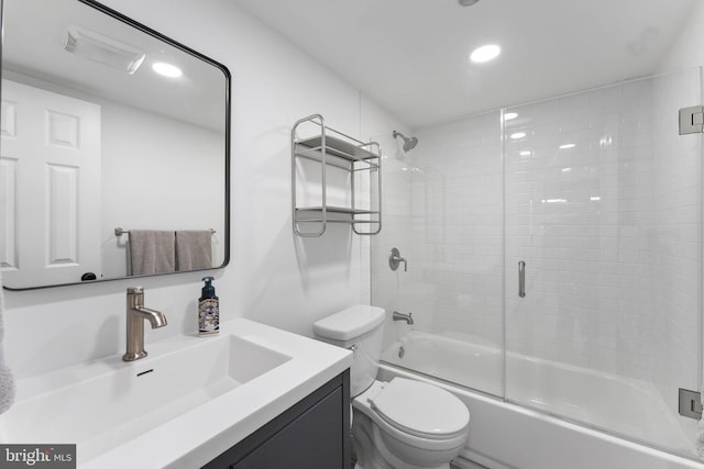 full bathroom with vanity, combined bath / shower with glass door, and toilet