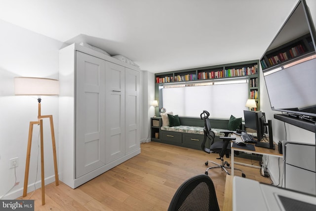 office area with light hardwood / wood-style floors