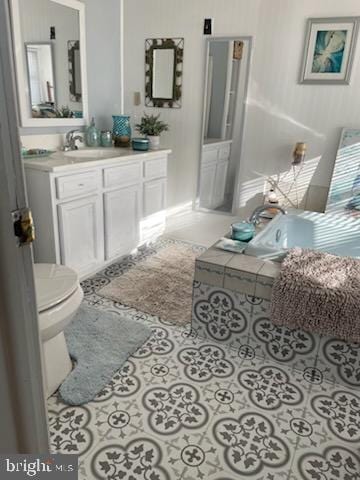 bathroom with vanity, tile patterned floors, and toilet