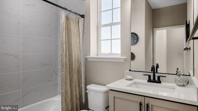 full bathroom with vanity, shower / tub combo with curtain, and toilet