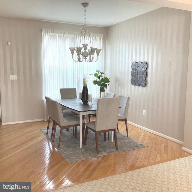 dining room with a notable chandelier and light hardwood / wood-style flooring