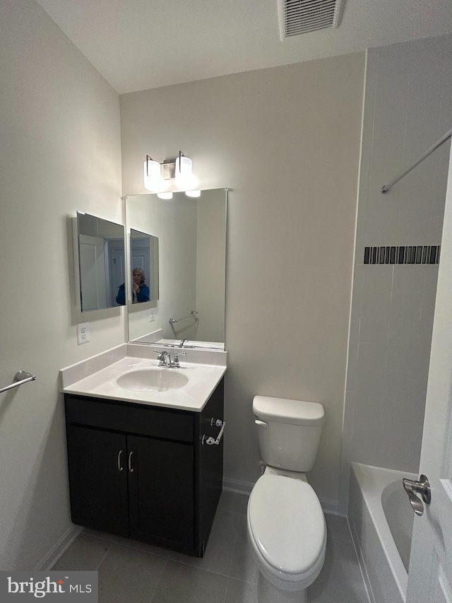 bathroom featuring vanity, toilet, tile patterned flooring, and a bathtub