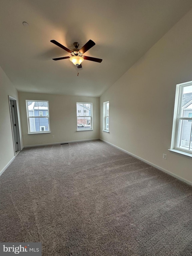 carpeted empty room with lofted ceiling and ceiling fan