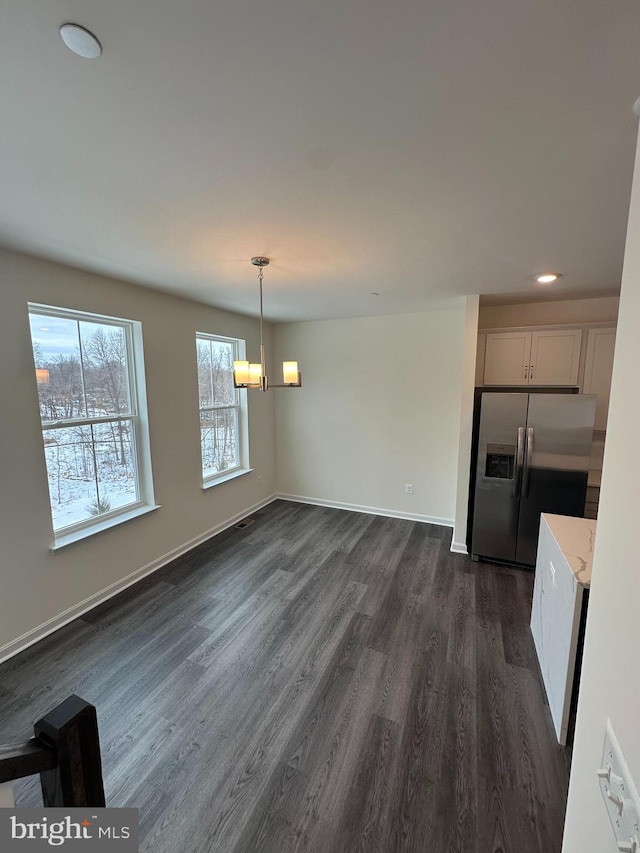 unfurnished dining area with dark hardwood / wood-style flooring