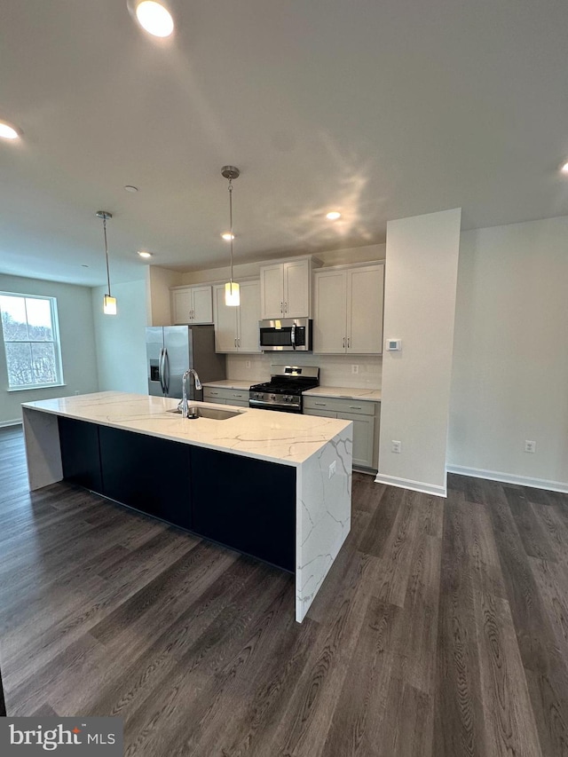 kitchen with pendant lighting, white cabinets, stainless steel appliances, and a spacious island