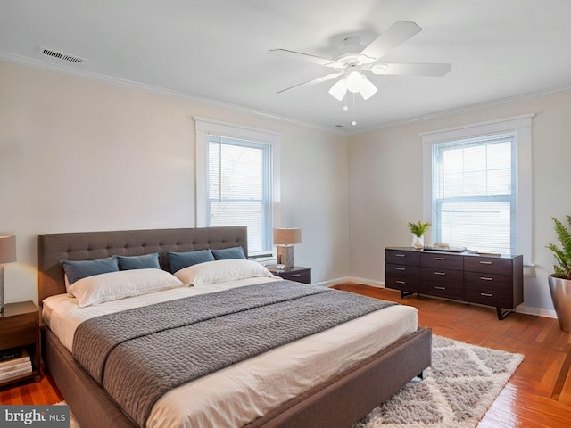 bedroom featuring multiple windows and ornamental molding