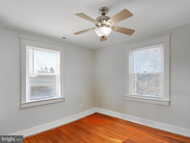 spare room featuring hardwood / wood-style flooring and crown molding